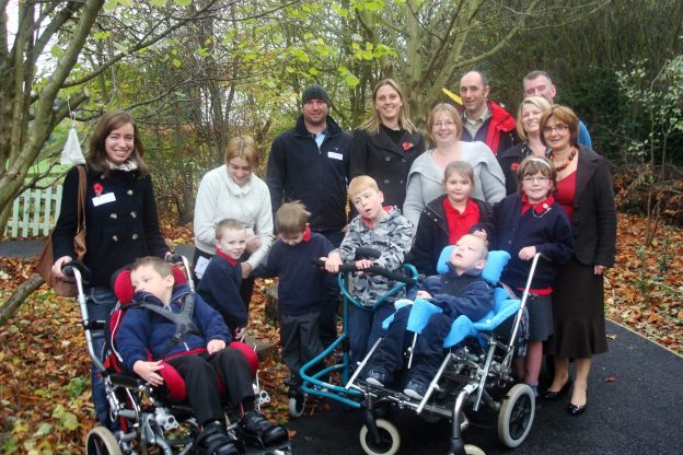 A group of people enjoying the great outdoors with some children of varying disability